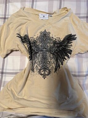 Daisy Cream Graphic Winged Cross V-Neck Tee